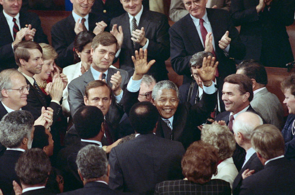 ANC leader Nelson Mandela raises his hands in response to a bipartisan standing ovation at the completion of his address to a joint meeting of Congress.<span class="copyright">Bettmann Archive/Getty Images</span>