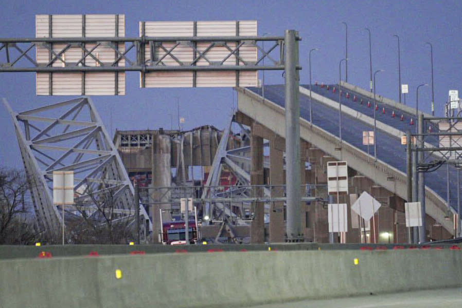 Parts of the Francis Scott Key Bridge remain after a container ship collided with a support Tuesday, March 26, 2024 in Baltimore. The major bridge in Baltimore snapped and collapsed after a container ship rammed into it early Tuesday, and several vehicles fell into the river below. Rescuers were searching for multiple people in the water. (Jessica Gallagher/The Baltimore Banner via AP)