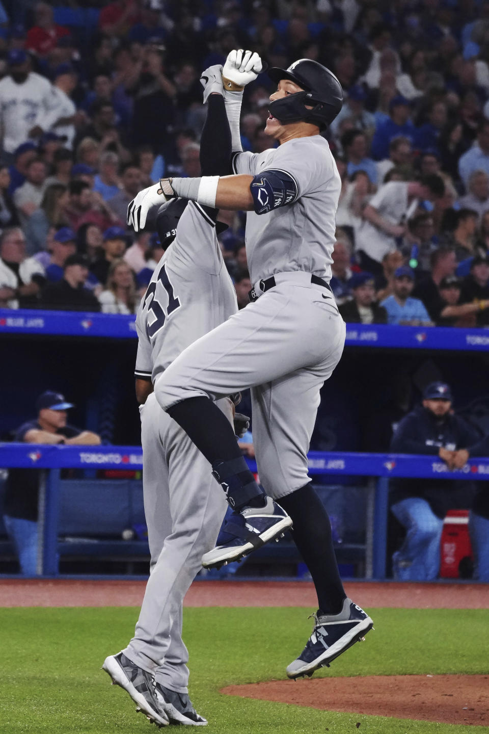 New York Yankees' Aaron Judge, right, celebrates his two-run home run against the Toronto Blue Jays with Aaron Hicks (31) during the eighth inning of a baseball game Tuesday, May 16, 2023, in Toronto. (Chris Young/The Canadian Press via AP)