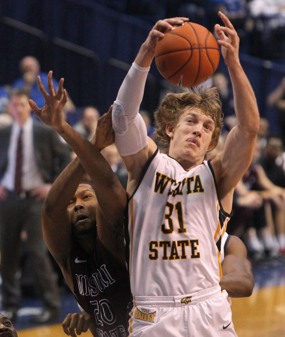Wichita State guard Ron Baker (31) pulls down a rebound against Missouri State forward Gavin Thurman during the first half of an NCAA college basketball game in the semifinals of the Missouri Valley Conference men's tournament Saturday, March 8, 2014, at the Scottrade Center in St. Louis. (AP Photo/St. Louis Post-Dispatch, Chris Lee) EDWARDSVILLE INTELLIGENCER OUT; THE ALTON TELEGRAPH OUT