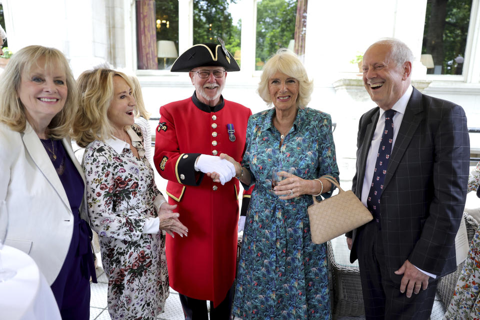 From left, Twiggy, Felicity Kendal, Chelsea pensioner Roy Palmer, Camilla, Duchess of Cornwall, and Gyles Brandreth, founder of Poetry Together, right, during The Oldie Luncheon, in celebration of Camilla's 75th Birthday at National Liberal Club in London, Tuesday, July 12, 2022. (Chris Jackson/Pool via AP)