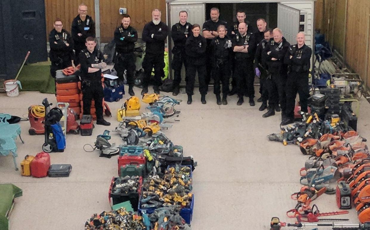 Members of Kent Police's Rural Task Force with part of the haul of suspected stolen items seized at a property near Cranbrook