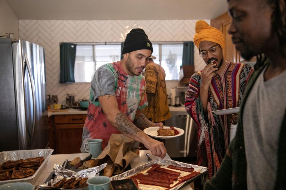 Bobby Brown, left, fills his plate with breakfast foods.