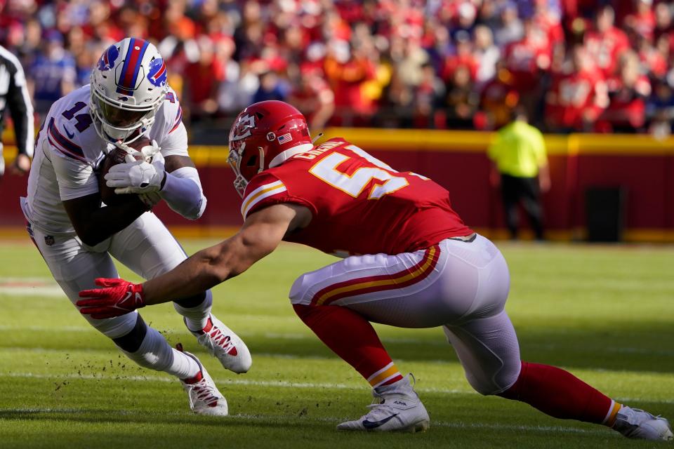 Buffalo Bills wide receiver Stefon Diggs (14) runs with the ball as Kansas City Chiefs linebacker Leo Chenal defends during the first half of an NFL football game Sunday, Oct. 16, 2022, in Kansas City, Mo. (AP Photo/Ed Zurga)