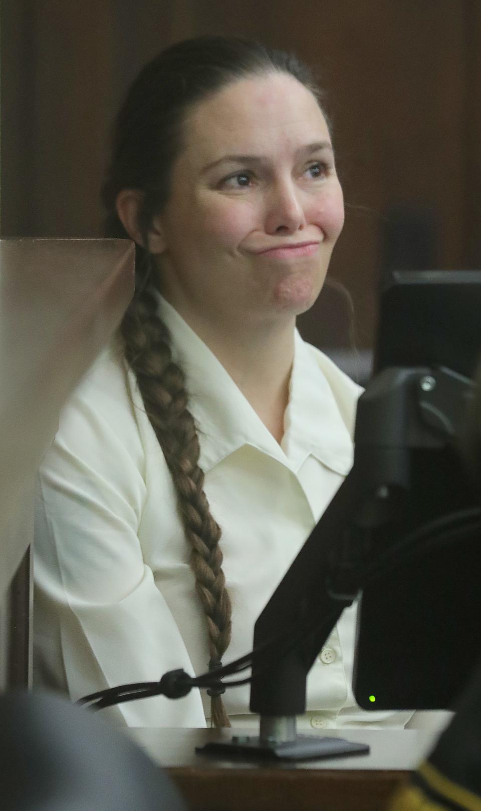 Erica Stefanko ponders a question from defense lawyer Jeff Laybourne while on the stand on Monday in Akron. Stefanko is being retried for her role in the 2012 murder of pizza delivery driver Ashley Biggs.