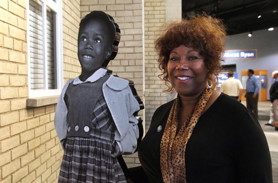 
Ruby Bridges poses next to a cutout of herself at age 6. She was the first black child to attend the all-white William Frantz Elementary School in Louisiana in 1960. She was escorted to her class by U.S. marshals every day, a scene immortalized by painter Normal Rockwell. 
