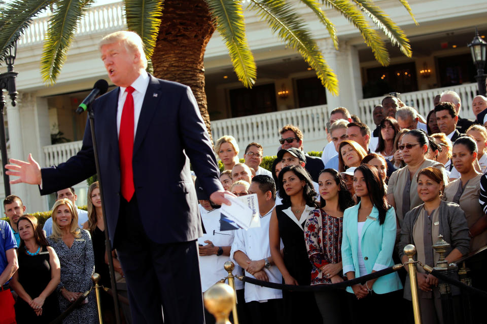 Employees of then-GOP presidential nominee Donald Trump stand behind him at a campaign event at his Trump National Doral golf club in Miami on Oct. 25, 2016.&nbsp; (Photo: Jonathan Ernst / Reuters)