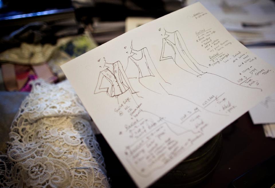 In this Aug. 20, 2013 photo, a sketch for a design by Carmen Marc Valvo is placed on fabric in his New York studio. Valvo's Spring 2014 collection will be shown during New York Fashion Week on Sept. 6 at Lincoln Center. (AP Photo/John Minchillo)