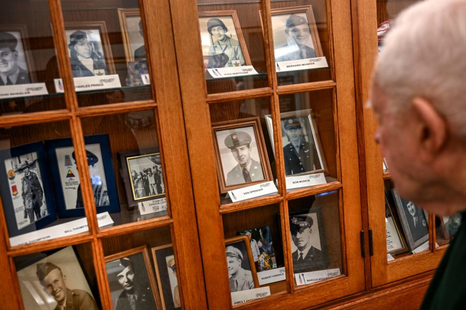 Richard Masters, who served in the U.S. Navy during World War II, looks at a display of other community members who served in the war on Tuesday, April 30, 2024, at the Hannah Community Center in East Lansing.
