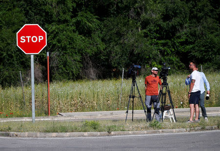 Journalists wait outside the prison where two of the five men cleared of gang rape of a teenager and convicted of a lesser crime of sexual abuse are due to leave jail after being granted provisional release in Alcala de Henares, near Madrid, Spain, June 22, 2018. REUTERS/Javier Barbancho