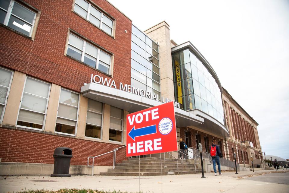 Students walk past the Iowa Memorial Union during the first combined city and school board elections, Tuesday, Nov., 5, 2019, along Madison Street in Iowa City, Iowa.