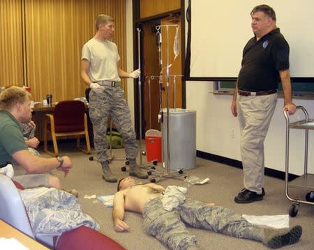 Dr. John Hagmann (R) teaches a course in treating battlefield trauma in this handout photograph taken around 2010 and released on June 17, 2015. REUTERS/HANDOUT via Reuters