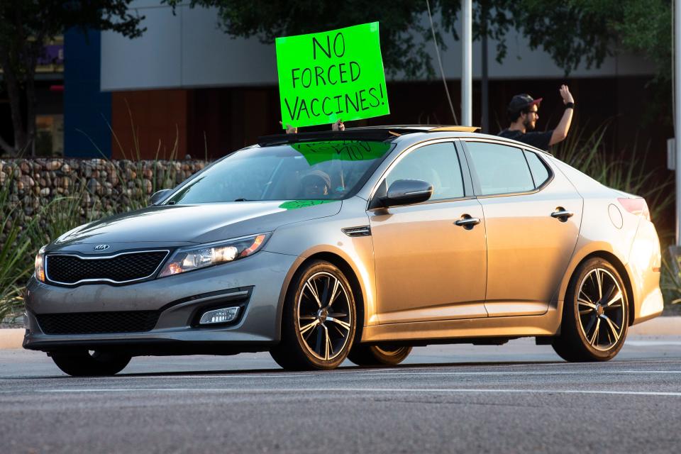 One of the many vehicles that drove by in support of the anti-vaxx protesters gathered outside Phoenix Children's Hospital in Arizona on Aug. 13, 2021.