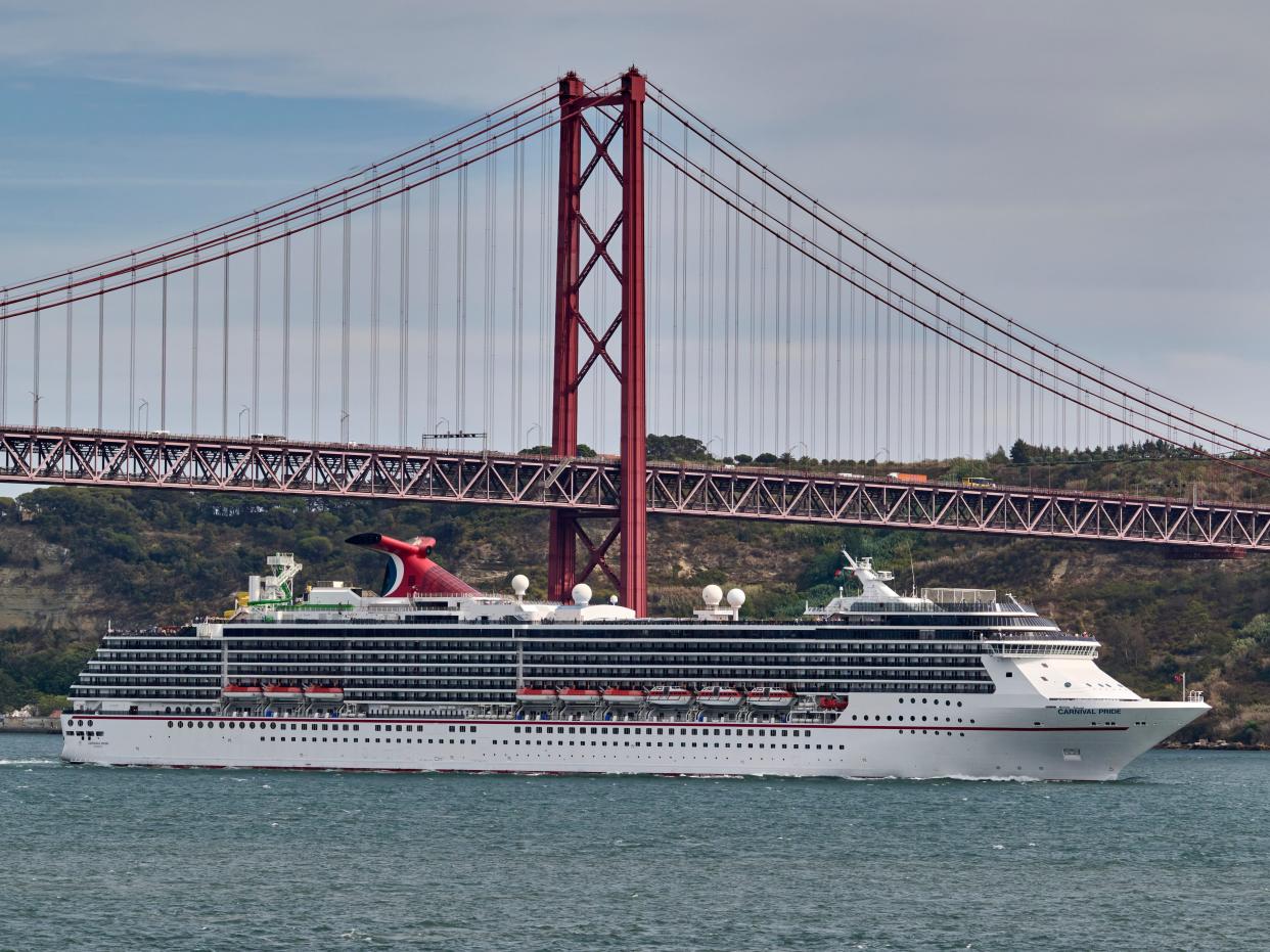 Carnival Pride, a Spirit-class cruise ship operated by Carnival Cruise Line, sails the Tagus River past 25 de Abril bridge after leaving the Cruise Terminal on September 07, 2022 in Lisbon, Portugal.