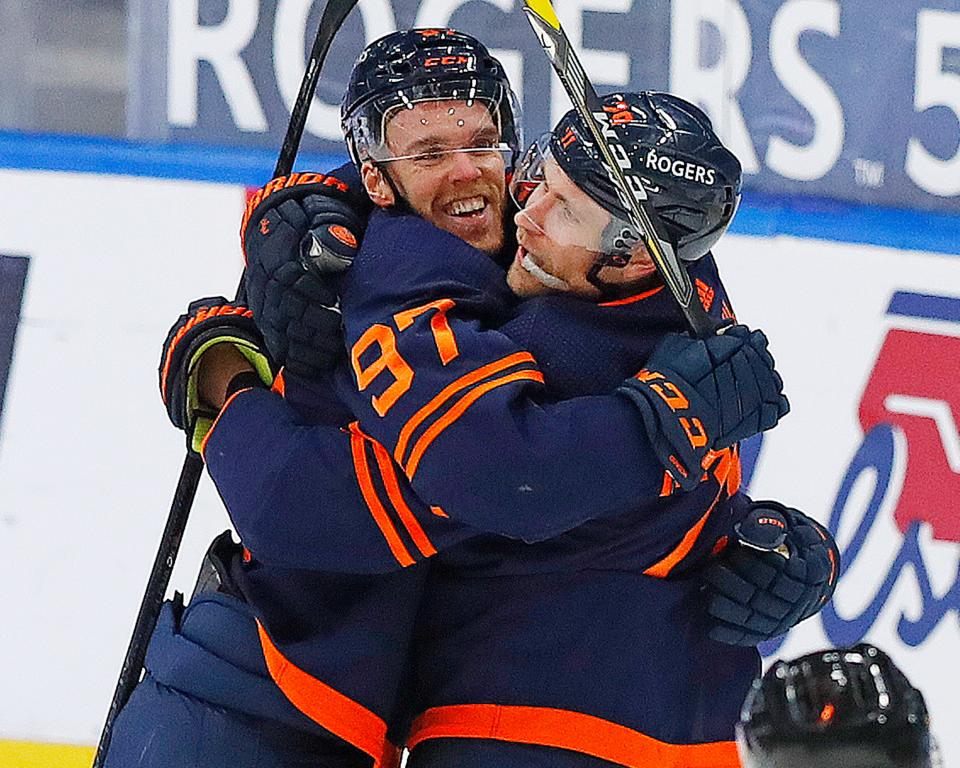Edmonton Oilers forward Connor McDavid celebrates with Leon Draisaitl after Draisaitl's goal late in the second period. McDavid earned his 100th point of the season with an assist on the goal.