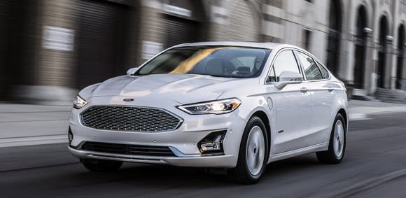 A white 2019 Ford Fusion Hybrid sedan, showing subtle changes to its front end