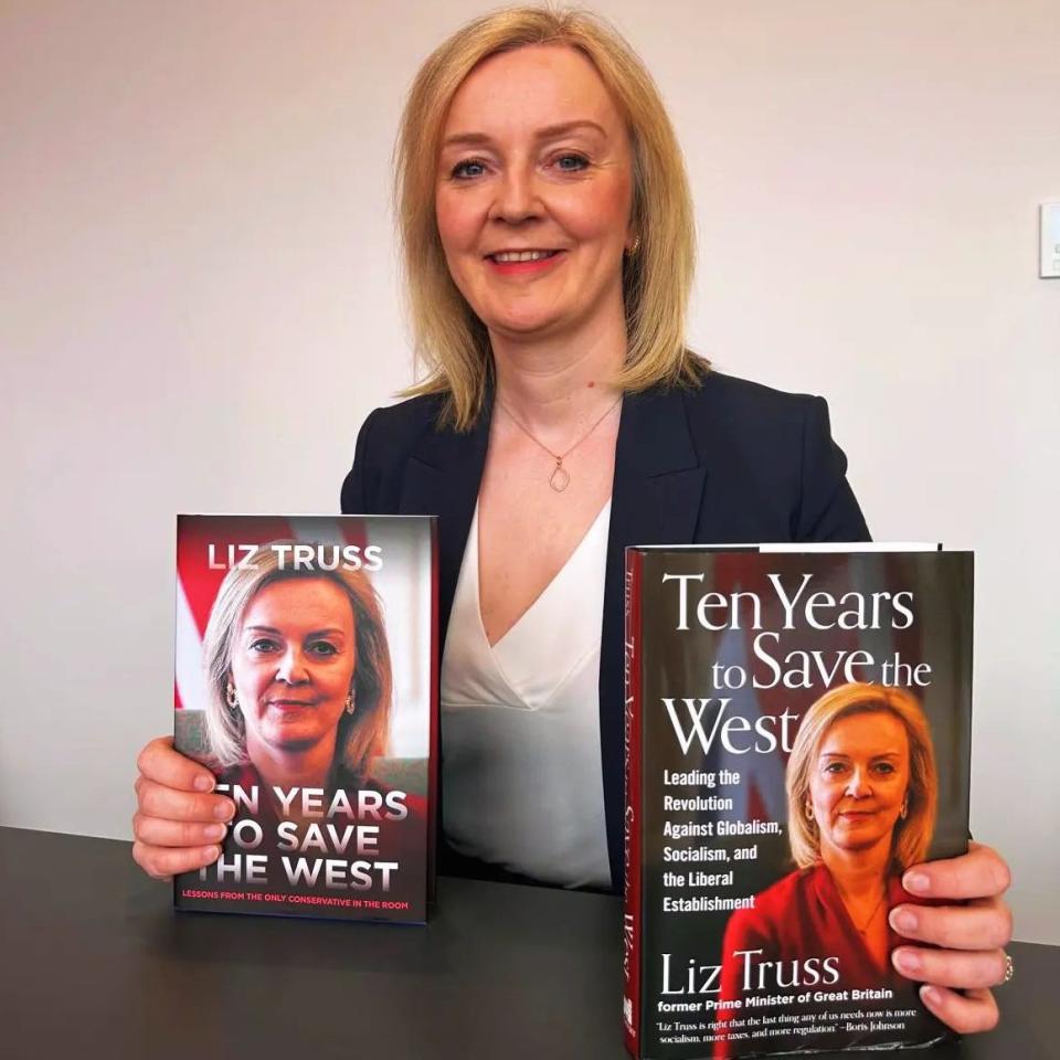 Liz Truss with her book