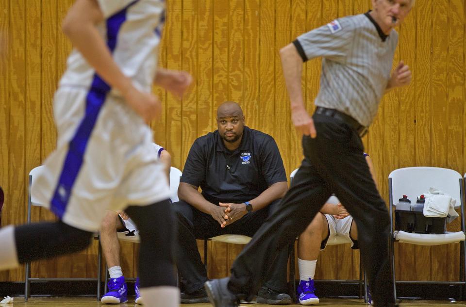 Olfen boys basketball coach Travis Tennison, center, watches from the bench as the team plays Mullin on Friday, Jan. 24, 2020.