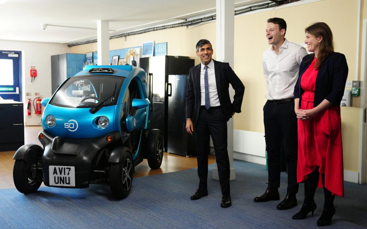 Rishi Sunak with Secretary of State for Science, Innovation and Technology, Michelle Donelan and Alex Kendall (centre), co-founder and CEO of Wayve, pause next to an autonomous car during a visit to the offices of Wayve Technologies in London