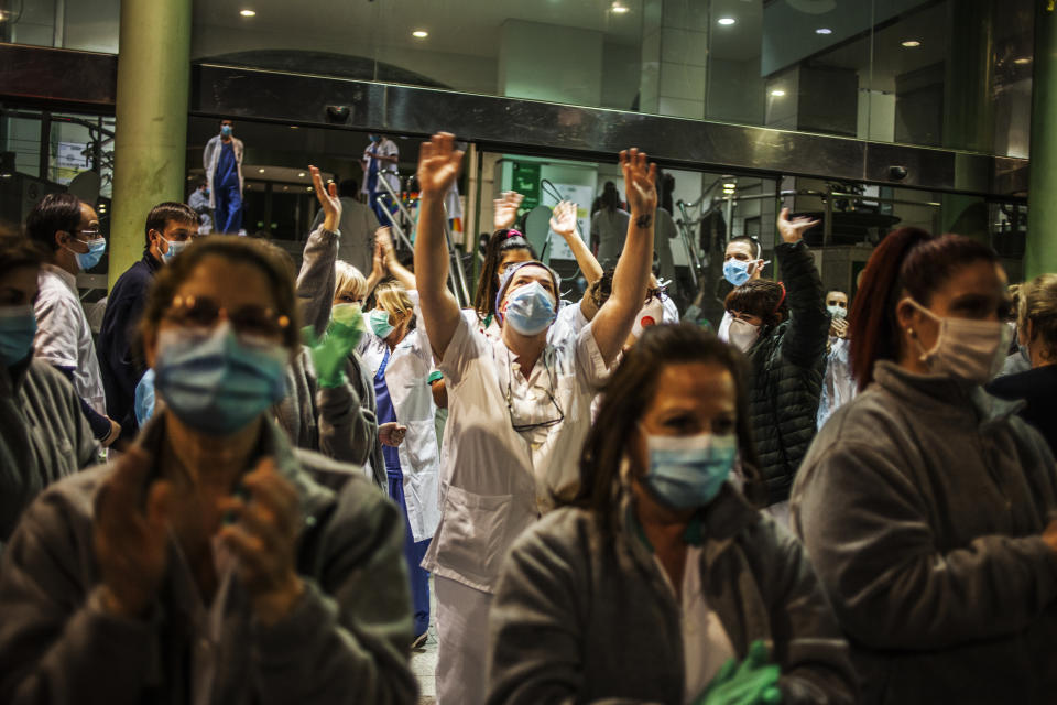 Health workers at the Hospital Clínico take to the streets and applaud the citizens who show gratitude from the streets and from their balconies and windows, during the outbreak of coronavirus disease, in Barcelona, Spain. (José Colon for Yahoo News)