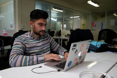 Student Julian Durdur, 23, refugee from Irak, works in his web development class as part of a professional training at the Simplon.co school specialized in digital sector in Montreuil, near Paris, France, June 14, 2018. Picture taken June 14, 2018. REUTERS/Philippe Wojazer