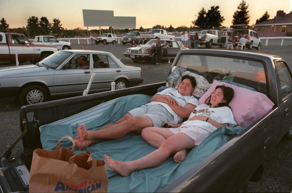 Scott Fuji and Krisit Ouy of Sacramento take in their first drive in movie of the year on Aug. 2, 1997 at the Sacramento 6, where the snuggled up to see “Face Off.”