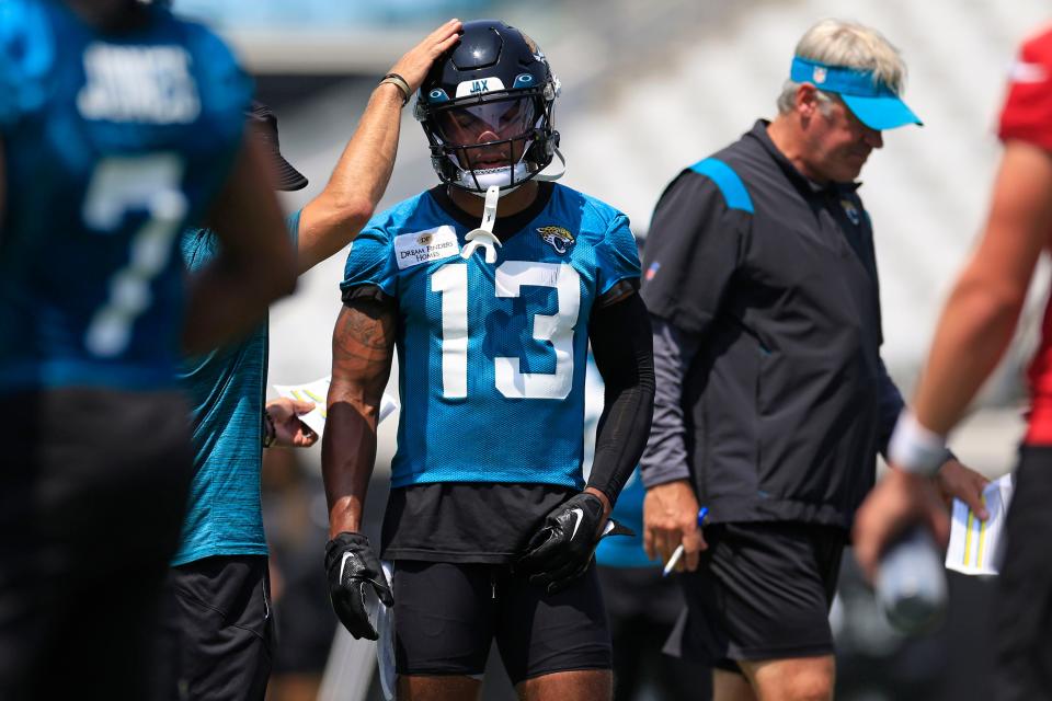 Jacksonville Jaguars wide receiver Christian Kirk (13)is tapped on the helmet during an organized team activity Tuesday, May 30, 2023 at TIAA Bank Field in Jacksonville, Fla. 