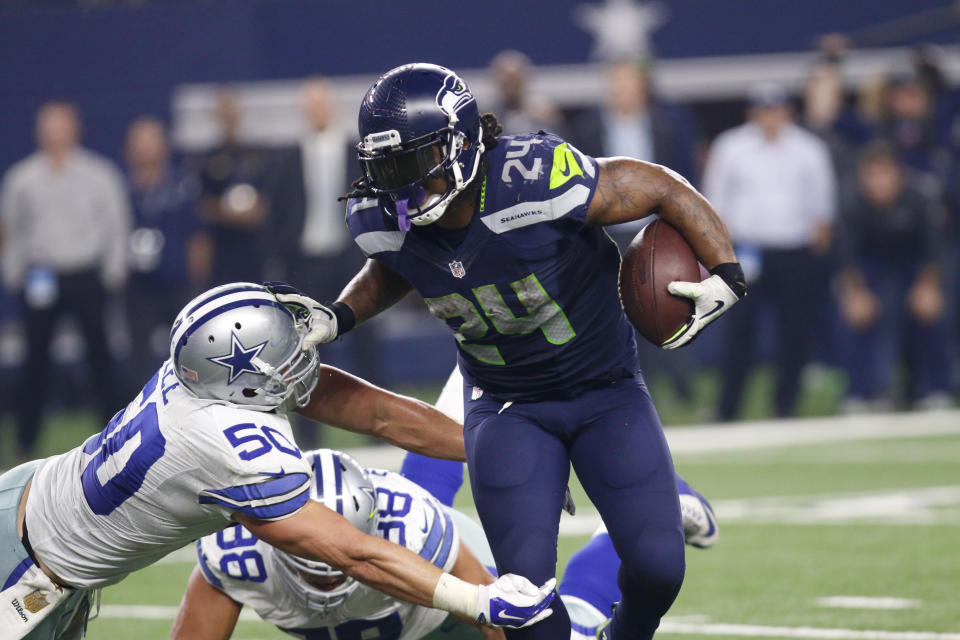 FILE - In this Nov. 1, 2015, file photo, Dallas Cowboys outside linebacker Sean Lee (50) defends against a run by Seattle Seahawks running back Marshawn Lynch (24) during an NFL football game in Arlington, Texas. The Seahawks could be reuniting with former star running back Lynch, coach Pete Carroll said during his radio show Monday, Dec. 23, 2019. Carroll said Lynch is flying to Seattle and will undergo a physical later Monday. Seattle is in desperate need of running backs after Chris Carson (hip) and C.J. Prosise (arm) both suffered season-ending injuries in Sunday’s 27-13 loss to Arizona. (AP Photo/Roger Steinman, File)