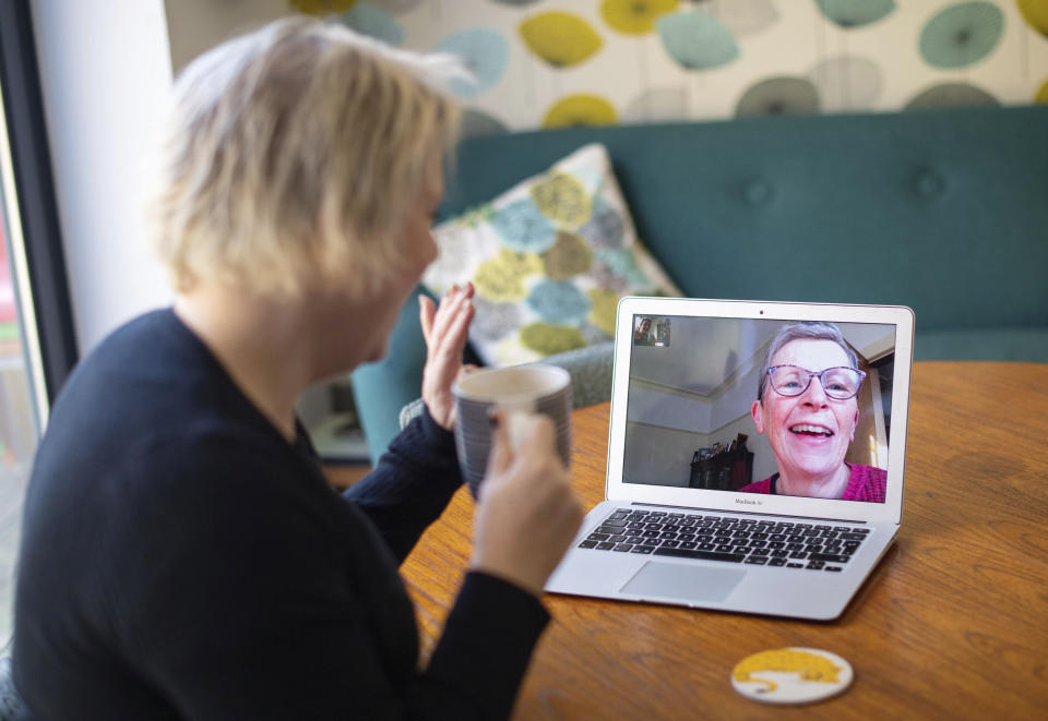 Helen Walters, left, talks to her mother Gillian using video calling, as people find alternative ways to celebrate Mother's Day to limit the potential spread of COVID-19 coronavirus, in London, Sunday March 22, 2020. Sunday is Mother’s Day in Britain and the government has a stark message for millions of citizens, that visiting your mom could kill her as for older adults and people with existing health problems, the virus can cause severe illness, including pneumonia. (Dominic Lipinski / PA via AP)