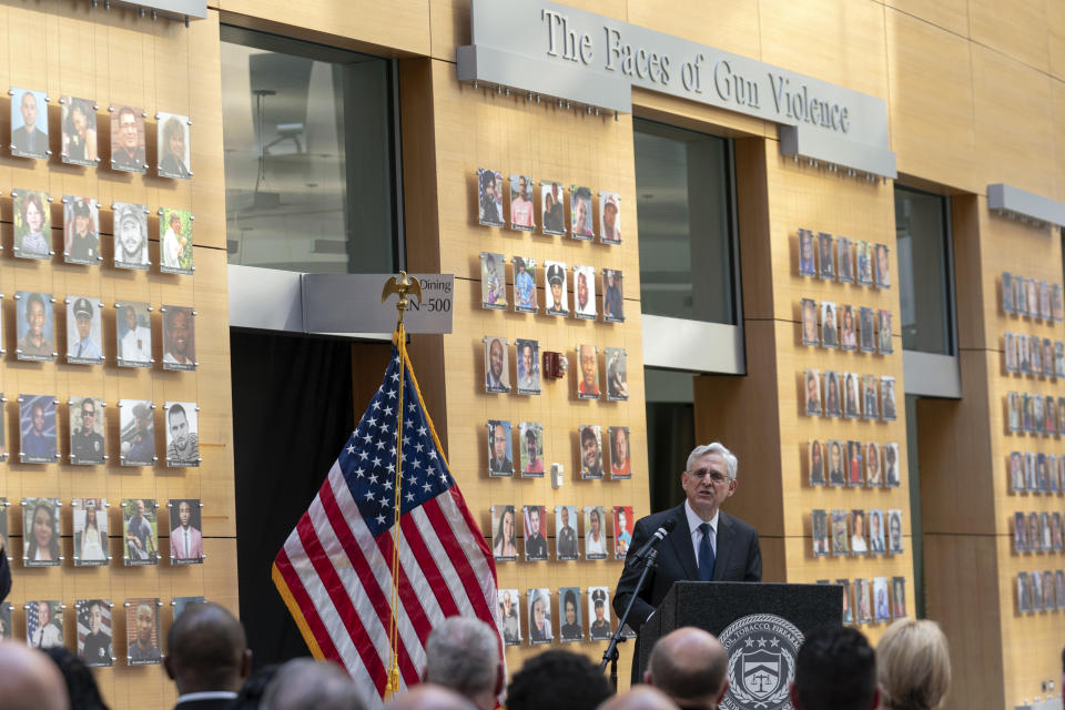 Attorney General Merrick Garland speaks next to a wall with photographs of victims of gun violence during the Inaugural Gun Violence Survivors' Summit at ATF Headquarters in Washington, Tuesday, April 23, 2024. (AP Photo/Jose Luis Magana)