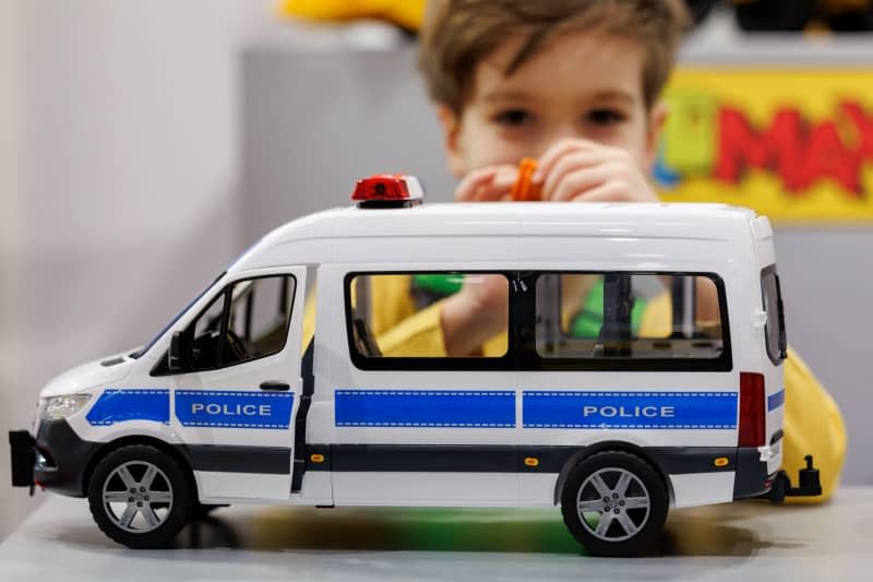 A child plays with a police vehicle at the stand of toy manufacturer Bruder during the 73rd International Toy Fair. From January 30 to February 3, 2024, the toy industry will meet in Nuremberg at the International Toy Fair. This year, the trade fair has proclaimed playing adults as the trend theme. Daniel Karmann/dpa