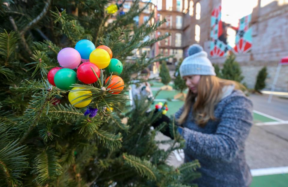 Ally Ogle decorates a tree at Lights On Main.