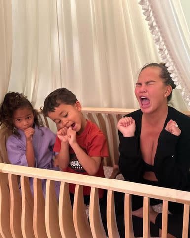 <p>chrissyteigen/Instagram</p> Chrissy Teigen with Luna and Miles