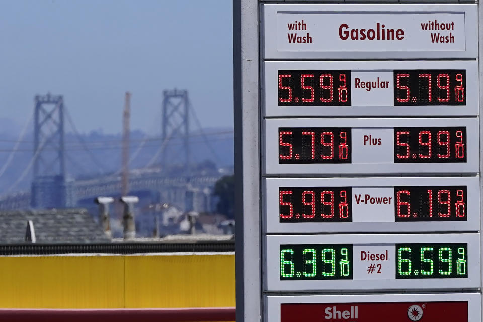 FILE - The San Francisco-Oakland Bay Bridge rises behind the price board of a gas station in San Francisco on July 20, 2022. The California Assembly on Monday, March 27, 2023, approved a bill that would let the California Energy Commission decide whether to penalize oil companies for price gouging. The bill now heads to Gov. Gavin Newsom, who has said he will sign it into law. (AP Photo/Jeff Chiu, File)