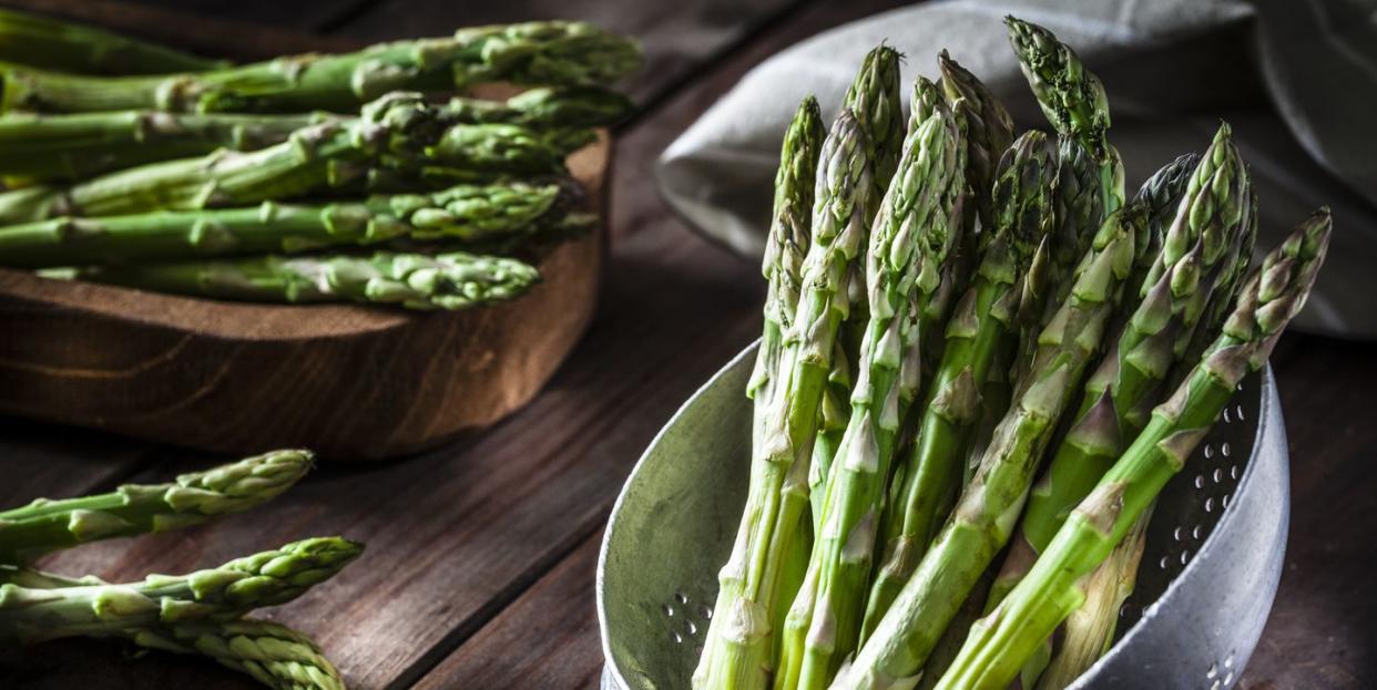 fresh asparagus in an old metal colander