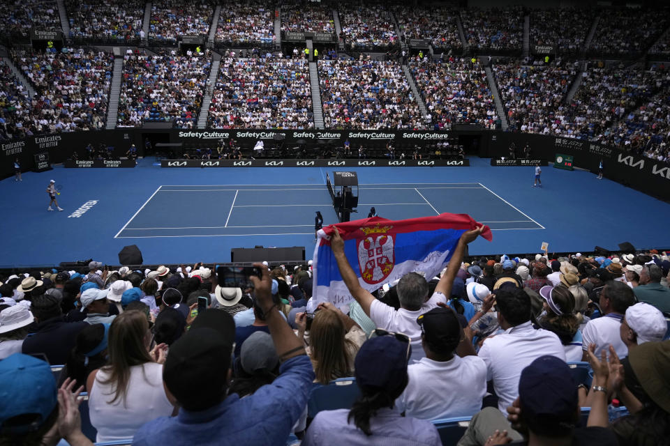 Supporters of Novak Djokovic of Serbia react during his semifinal against Jannik Sinner of Italy at the Australian Open tennis championships at Melbourne Park, Melbourne, Australia, Friday, Jan. 26, 2024. (AP Photo/Alessandra Tarantino)