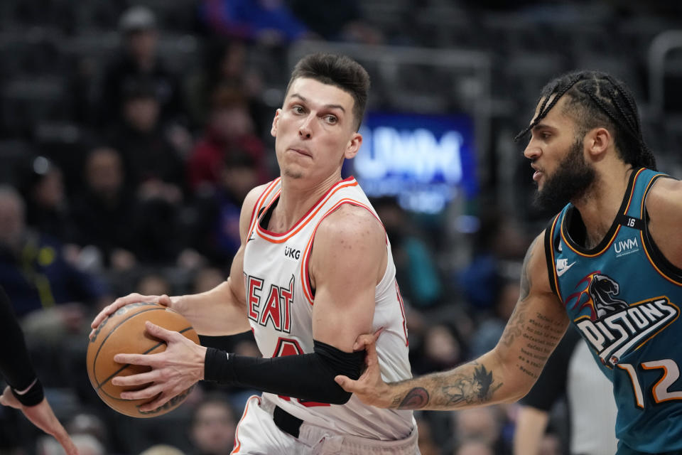 Miami Heat guard Tyler Herro is defended by Detroit Pistons forward Isaiah Livers (12) during the second half of an NBA basketball game, Tuesday, April 4, 2023, in Detroit. (AP Photo/Carlos Osorio)