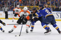 St. Louis Blues center Brayden Schenn (10) and defenseman Vince Dunn (29) defend against Philadelphia Flyers center Sean Couturier (14) during the first period of an NHL hockey game Wednesday, Jan. 15, 2020 in St. Louis. (AP Photo/Dilip Vishwanat)