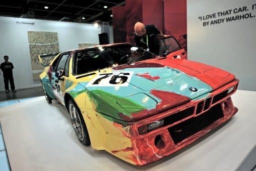 An emplyee is seen polishing the windshield of a car painted by Andy Warhol at Asia's premier art fair "Art HK," in Hong Kong, on May 16. Traditionally known as a centre of banking and finance, Hong Kong has become a hub of all things luxury -- from fine wine to fashion and, increasingly, art -- thanks to the explosion of personal wealth among mainland Chinese