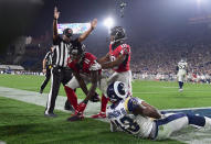 <p>Wide receiver Julio Jones #11 of the Atlanta Falcons makes a touchdown catch in front of strong safety John Johnson #43 of the Los Angeles Rams as wide receiver Taylor Gabriel #18 celebrates during the fourth quarter of the NFC Wild Card Playoff game at Los Angeles Coliseum on January 6, 2018 in Los Angeles, California. (Photo by Harry How/Getty Images) </p>