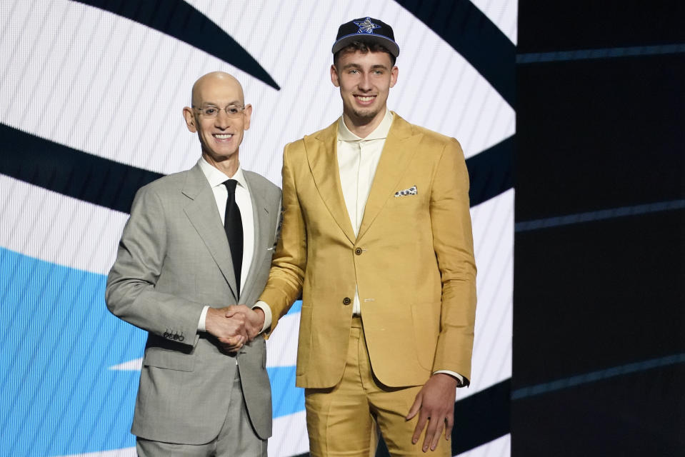 Franz Wagner, right, poses for a photo with NBA Commissioner Adam Silver after being selected eighth overall during the NBA basketball draft, Thursday, July 29, 2021, in New York. - Credit: AP