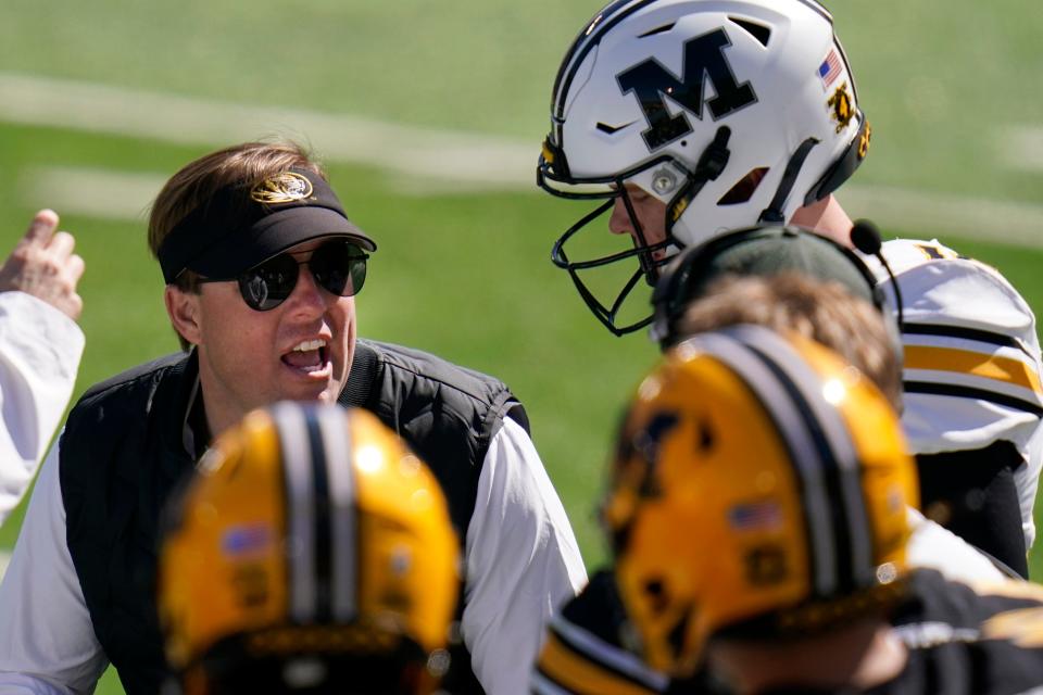 Missouri head coach Eli Drinkwitz, left, talks with quarterback Brady Cook during the Tigers' spring game in March.