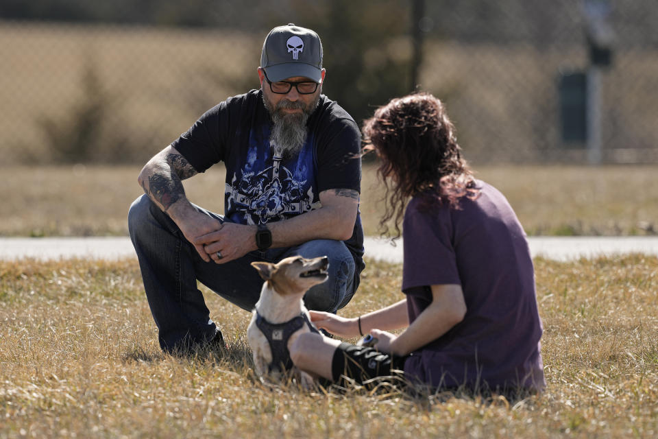 Dusty Farr talks with his transgender daughter in a park near Smithville, Mo., Sunday, Feb. 25, 2024. Farr is suing the Platt County School District after his daughter was suspended for using the girl's bathroom at the Missouri high school she attended. (AP Photo/Charlie Riedel)