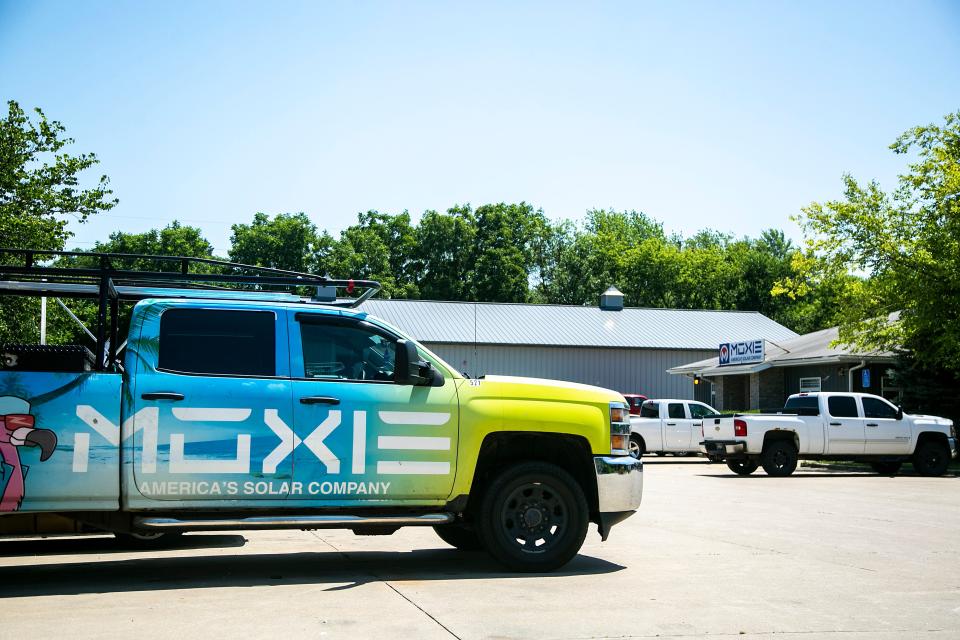 Vehicles park outside the Moxie Solar headquarters building, Tuesday, July 5, 2022, in North Liberty, Iowa.