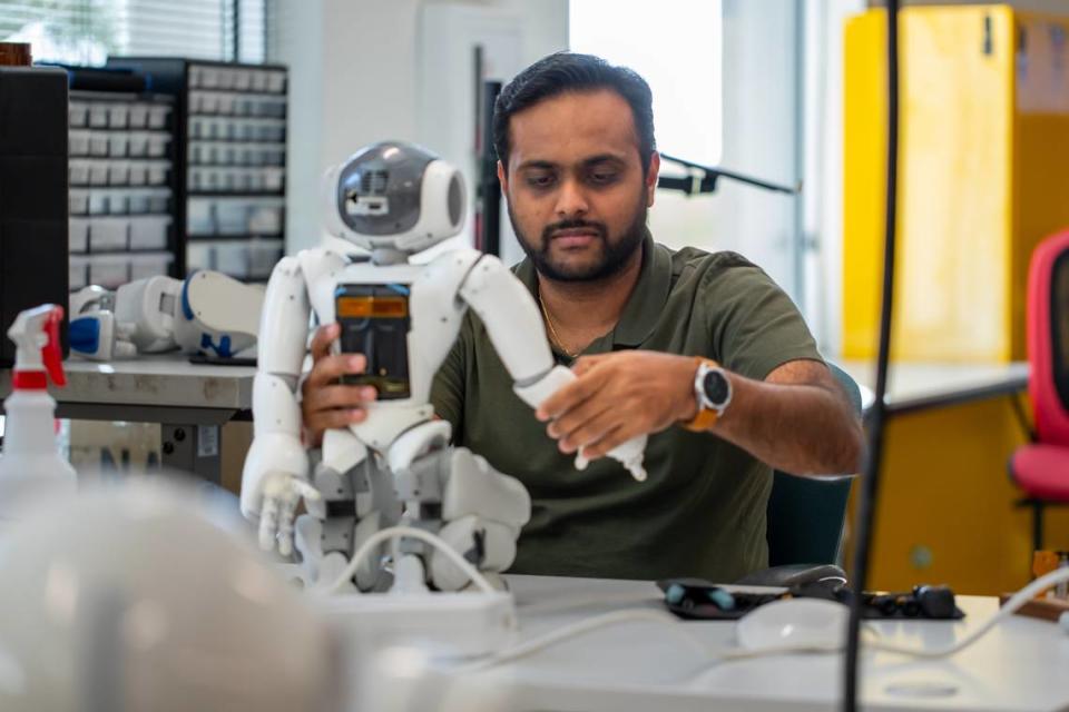 Neel Patel, co-franchise owner of RobotLAB in Charlotte, works on an artificial intelligence-powered robot.