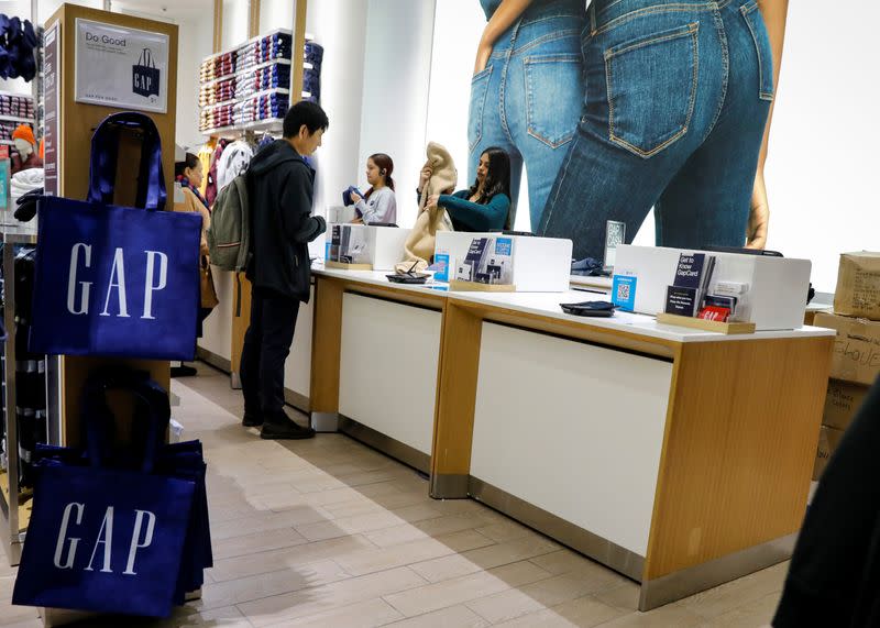 FILE PHOTO: Holiday shoppers take part in early Black Friday shopping deals at the Gap store on the Thanksgiving holiday in Times Square in New York