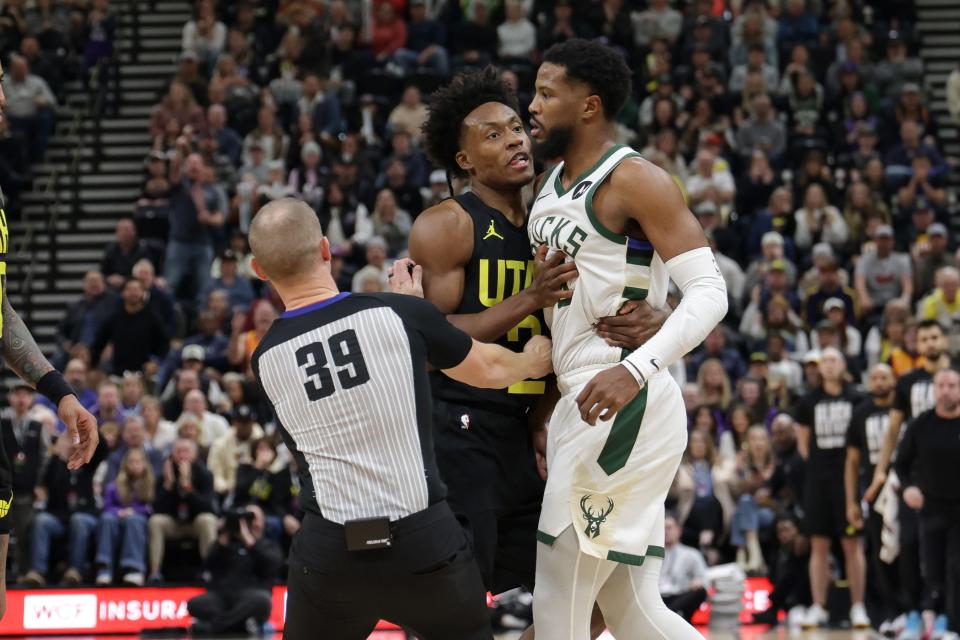 Referee Tyler Ford tries to separate Jazz guard Collin Sexton and Bucks guard Malik Beasley after the two got into an altercation during the second quarter Sunday night.