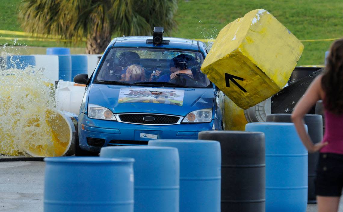 Alex Jacobs, 27, driving, and his teammate, Nadine Pelovich, 25, snake their way through the “Liquid Slalom” obstacle course, in Bicentennial Park, where the search for the “Worst Driver” in Miami was held Sept. 22, 2009.