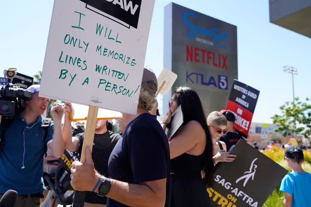 A demonstrator in Los Angeles holds a sign reading, 