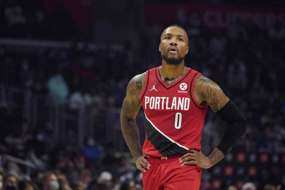 Portland Trail Blazers guard Damian Lillard walks on the court during the first half of an NBA basketball game against the Los Angeles Clippers Monday, Oct. 25, 2021, in Los Angeles. (AP Photo/Marcio Jose Sanchez)